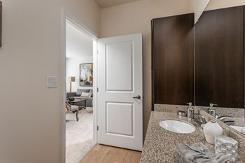 a bathroom with a sink and a mirror and a closet at 310 at Nulu Apartments-Student, Louisville Kentucky